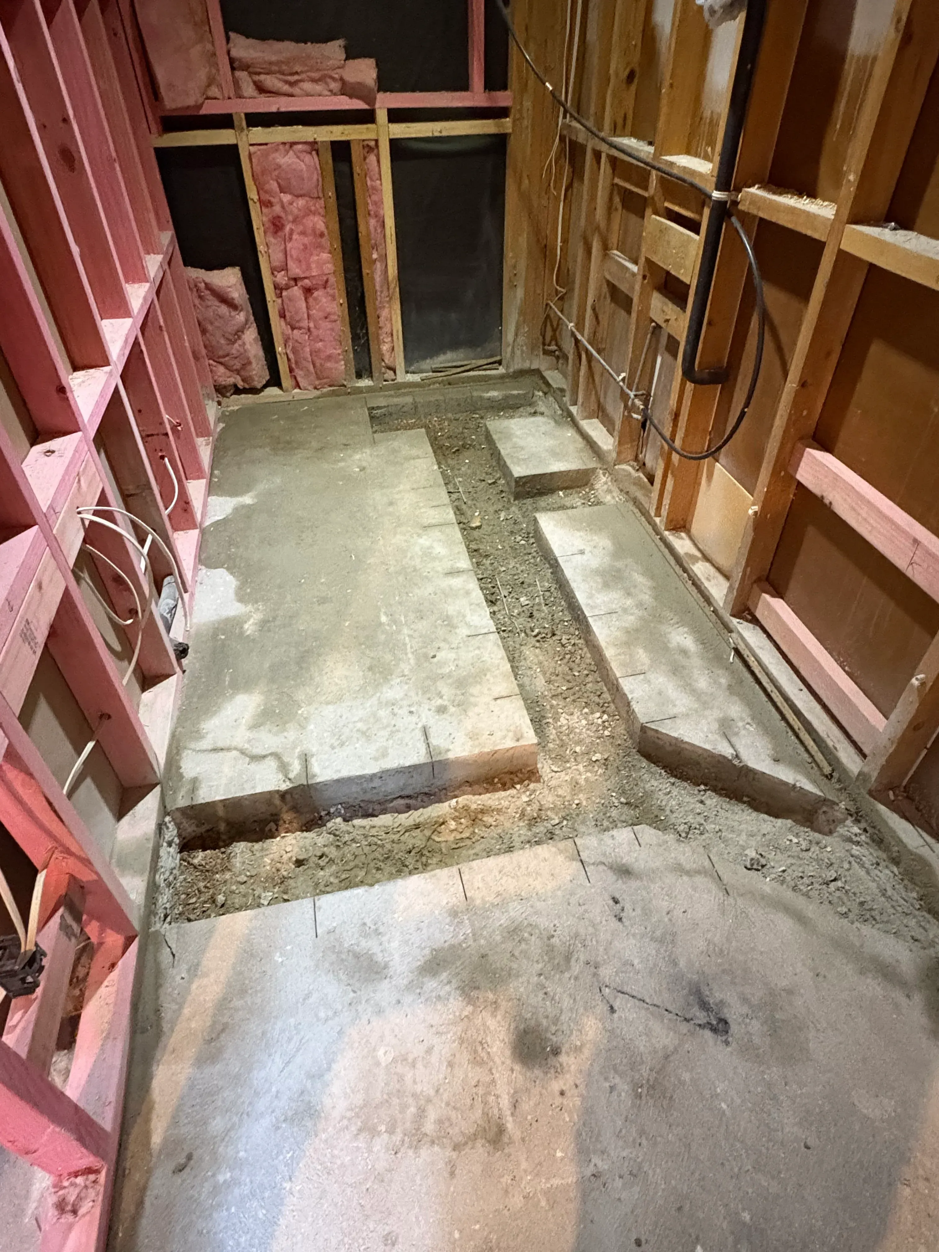 Chase cutting channels into concrete wall