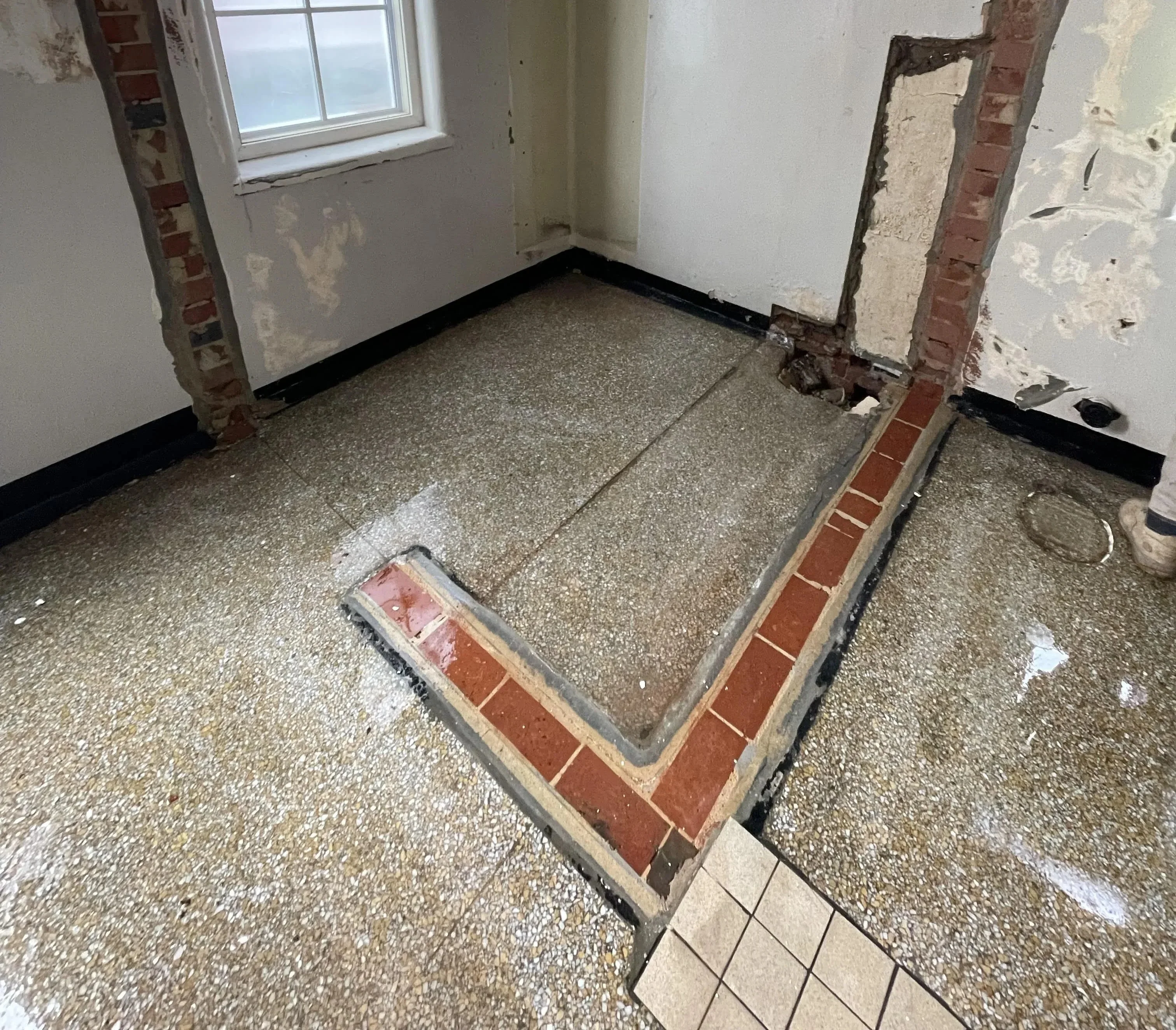 Flush cutting concrete against existing wall